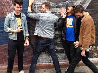 Bastille  Dan Smith and the other band members in a comic pose.